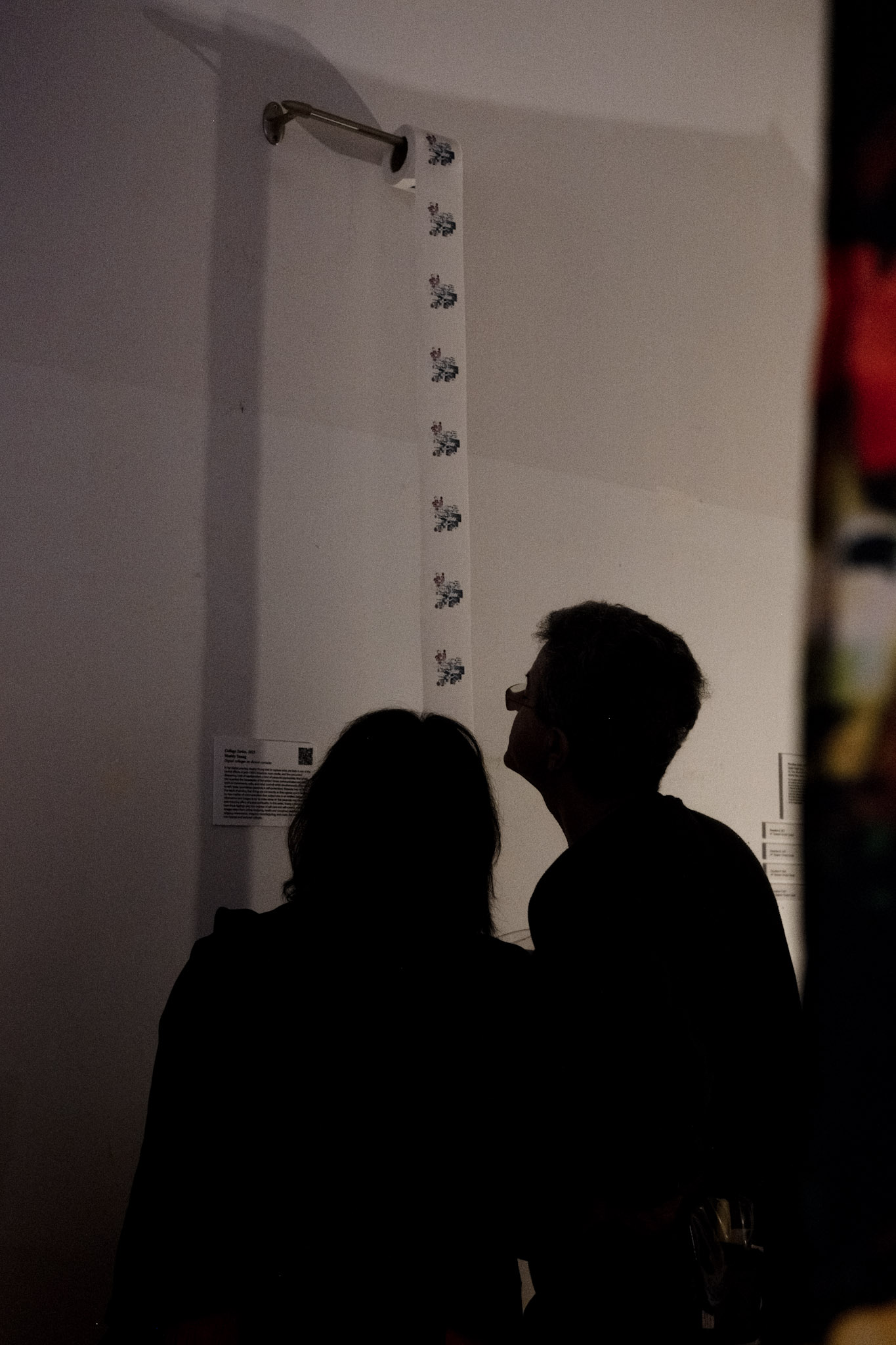 Two visitors viewing artwork at the gallery reception